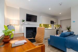 a living room with a blue couch and a table at Charlotte Rise in Bristol