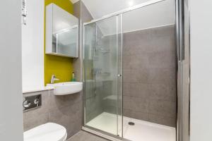 a bathroom with a shower and a toilet and a sink at Charlotte Rise in Bristol