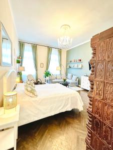 a bedroom with a large bed and a living room at The Spot with Green Chair - cozy space near Danube in Budapest