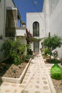 a house with a walkway in front of a building at B&B Pulia Dimore Salentine Leuca in Alessano