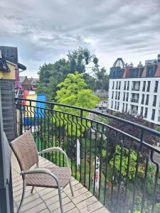 a balcony with two chairs and a view of a city at B & B Tomula in Gdańsk