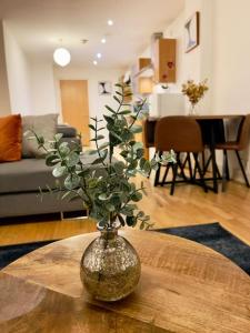 a vase sitting on a table in a living room at Beautiful Central Open plan living! in Manchester