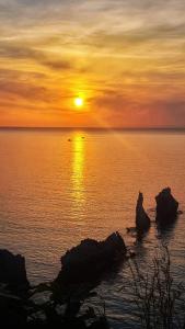 テッラジーニにあるHoliday House Ladyの海上の岩石の夕日