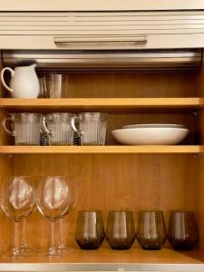 a shelf with wine glasses and plates on it at Beautiful Central Open plan living! in Manchester