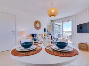 a dining room with a table with plates and wine glasses at AL - Vilamoura Algardia in Vilamoura