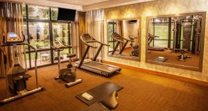 a gym with several exercise equipment in a room at Garden Court Hatfield in Pretoria