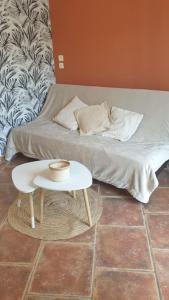 a bed with a table in a room at Bienvenue chez nous 