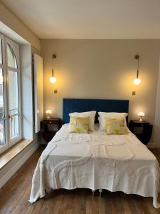 a bedroom with a large white bed with yellow pillows at Loft me - Entre art deco et loft à l'americaine in Périgueux
