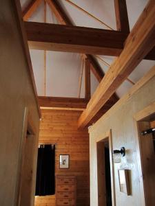 a room with a ceiling with wooden walls and wooden beams at Towerhouse - Modern Cabin @ 8,000ft in Wanship