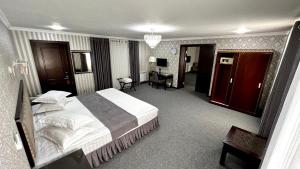 a hotel room with a large bed in a room at Za'faron Hotel in Jizzax