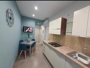 a kitchen with a sink and a table in a room at Playa degli Angeli Grecale in Gabicce Mare