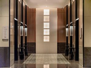 a hallway of a building with glass doors and lights at Four Points by Sheraton Guangzhou, Baiyun in Guangzhou
