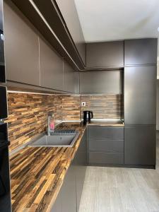 a kitchen with a sink and a wooden counter top at VALENCIA GARDENS ROYAL in Nesebar