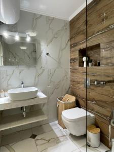 a bathroom with a sink and a toilet at VALENCIA GARDENS ROYAL in Nesebar