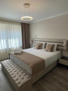 a bedroom with a large bed and a large window at VALENCIA GARDENS ROYAL in Nesebar