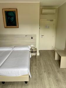 Postel nebo postele na pokoji v ubytování Hotel Bazzoni