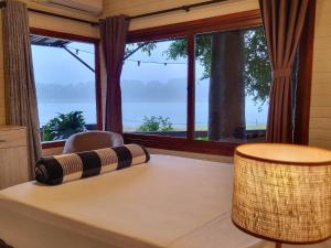 a room with a table with a large window at La Casa Del Lago URUGUA-Í in Puerto Iguazú