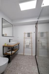 La salle de bains est pourvue d'un lavabo, de toilettes et d'un miroir. dans l'établissement B&B Miracolo di Mare Golden House, à Piran