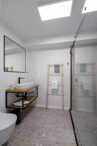 a bathroom with a sink and a toilet and a mirror at Miracolo di Mare Golden House in Piran
