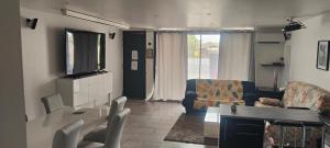 a living room with a couch and a table at Location maison avec piscine privée. in Agde