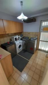a kitchen with a stove and a washing machine at Y.M.Apartment in Rhodes Town