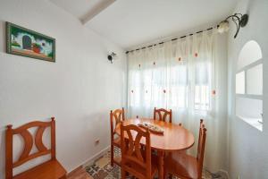 a dining room with a table and chairs and a window at Casa Lalu in San José +9 photos