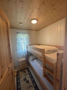 a bedroom with two bunk beds in a cabin at Bjørgo Gard - Stegastein in Aurland