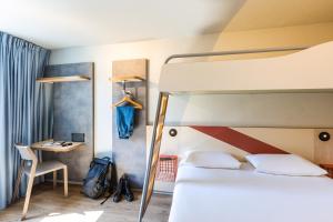 a bedroom with a bed and a desk and a bunk bed at ibis budget Angoulême Centre in Angoulême