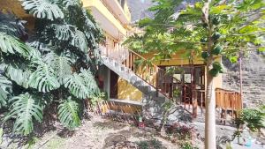 a building with a staircase next to some trees at Casa Cavoquinho in Paul