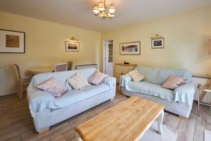 a living room with two couches and a table at Host & Stay - Sandpipers in Belford