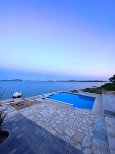 a swimming pool with a view of the water at La Isla in Tkon