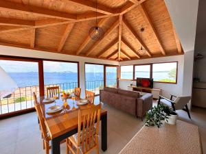 a dining room with a table and a couch at La Isla in Tkon