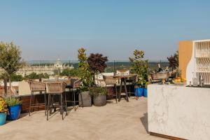 a patio with tables and chairs on a roof at Palacio de los Duques Gran Meliá - The Leading Hotels of the World in Madrid