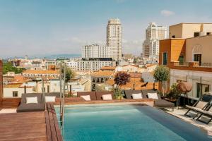 a swimming pool on the roof of a building at Palacio de los Duques Gran Meliá - The Leading Hotels of the World in Madrid