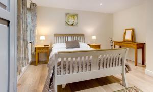 a bedroom with a bed and a crib at Tewitfield Marina in Carnforth