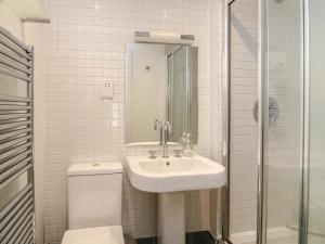 a bathroom with a sink and a toilet and a shower at 5 Combehaven in Salcombe