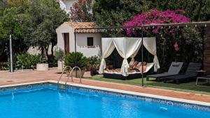 a swimming pool in front of a house at La Cañota Suite King Rooms Adults Only in Talara