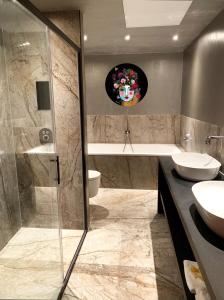 a bathroom with a shower and a toilet and a sink at Landhuishotel De Bloemenbeek in De Lutte
