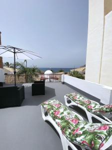 a patio with two lounge chairs on a roof at Casa Keko in La Herradura