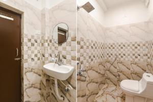 a bathroom with a sink and a toilet at FabExpress Elite Inn in Patna