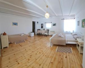 a large living room with wooden floors and a couch at Dembelija Rooms in Virpazar