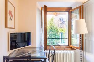 a room with a desk and a window at La Camelia d'Oro in Oggebbio
