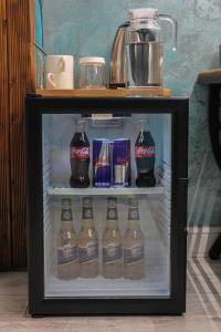 a mini refrigerator filled with bottles of cocacola at E-lite& Meatador in Astana