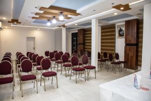 a room with a bunch of chairs in a room at SSNIT GUEST HOUSE in Nima