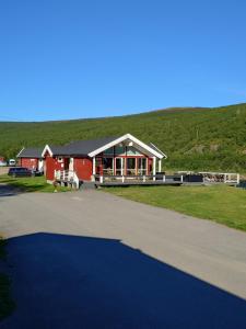 a large red barn with a large driveway at Levajok Lodge in Tana