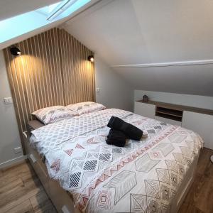 a bedroom with a bed with a purse on it at La Cabane des Bords de Loire in Saint-Sébastien-sur-Loire