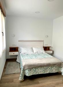 Łóżko lub łóżka w pokoju w obiekcie Apartamento Valbuena