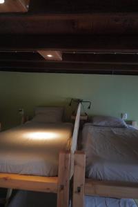 two bunk beds in a room with a wall at The Pink House in Faja Grande