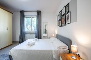 a bedroom with a bed and a table and a window at Homiday - New House - Pisa Aeroporto - Free Parking in Pisa