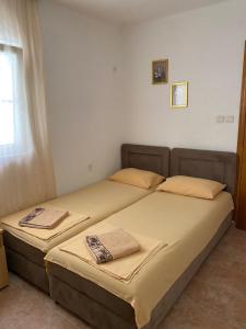 a bed in a room with two pillows on it at Vila Zara in Donji Štoj